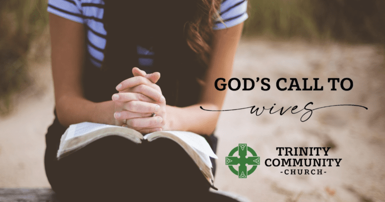 Woman Praying while reading her bible, hands folded.
